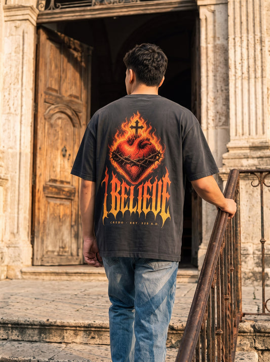 Credo — Burning Heart Tee, back, black. On the church steps at golden hour.